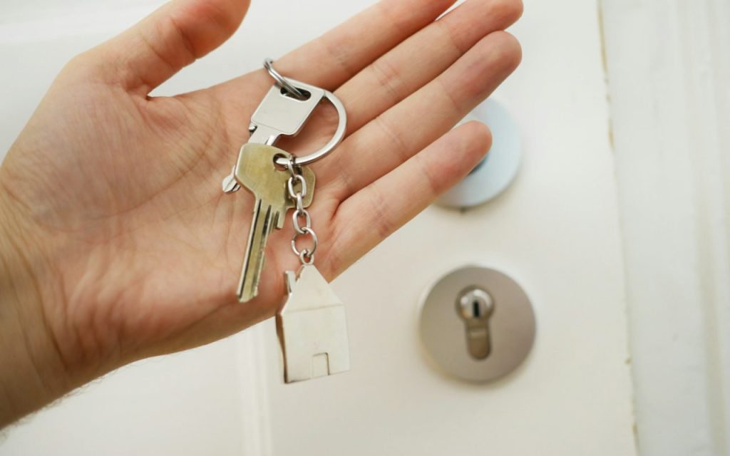 A hand holding a set of house keys