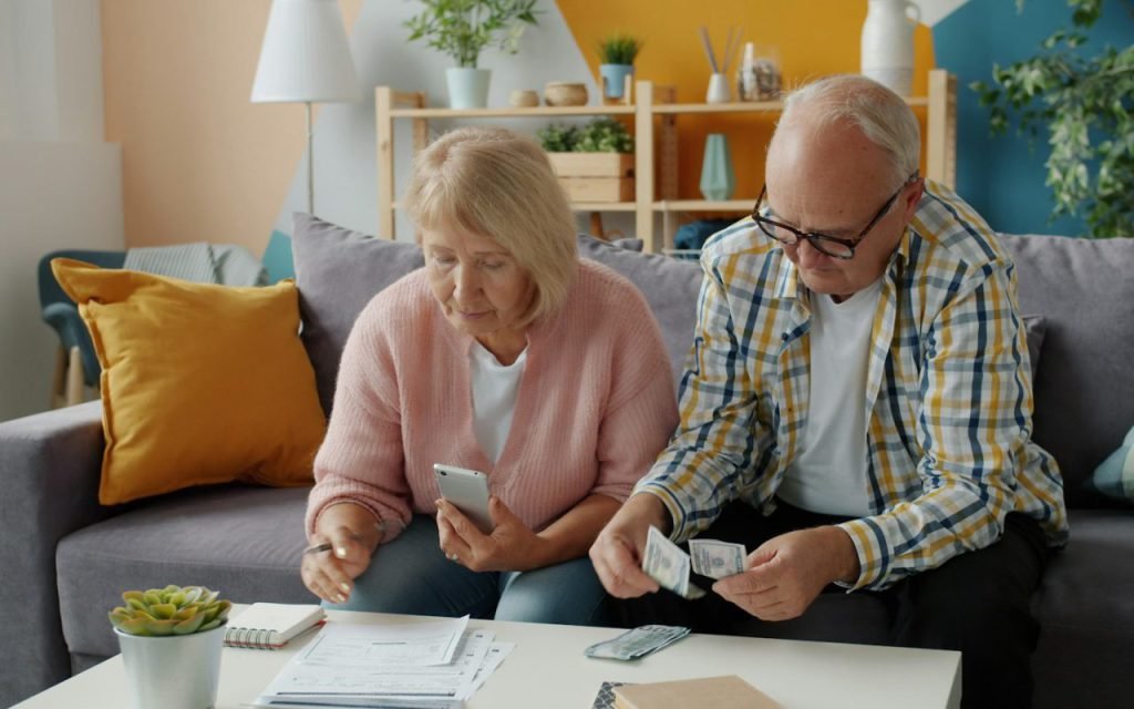 An older couple reviewing paperwork together at a table