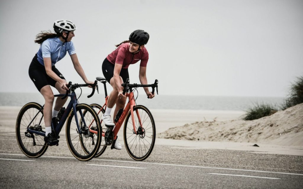 Two people riding bicycles together at an easy pace