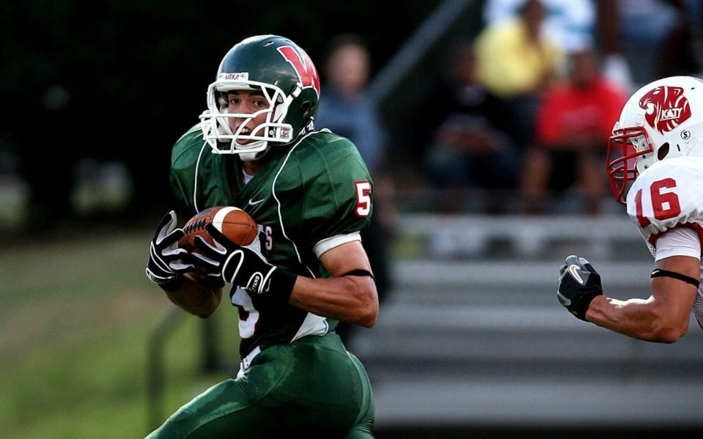 A football player in uniform preparing for a play