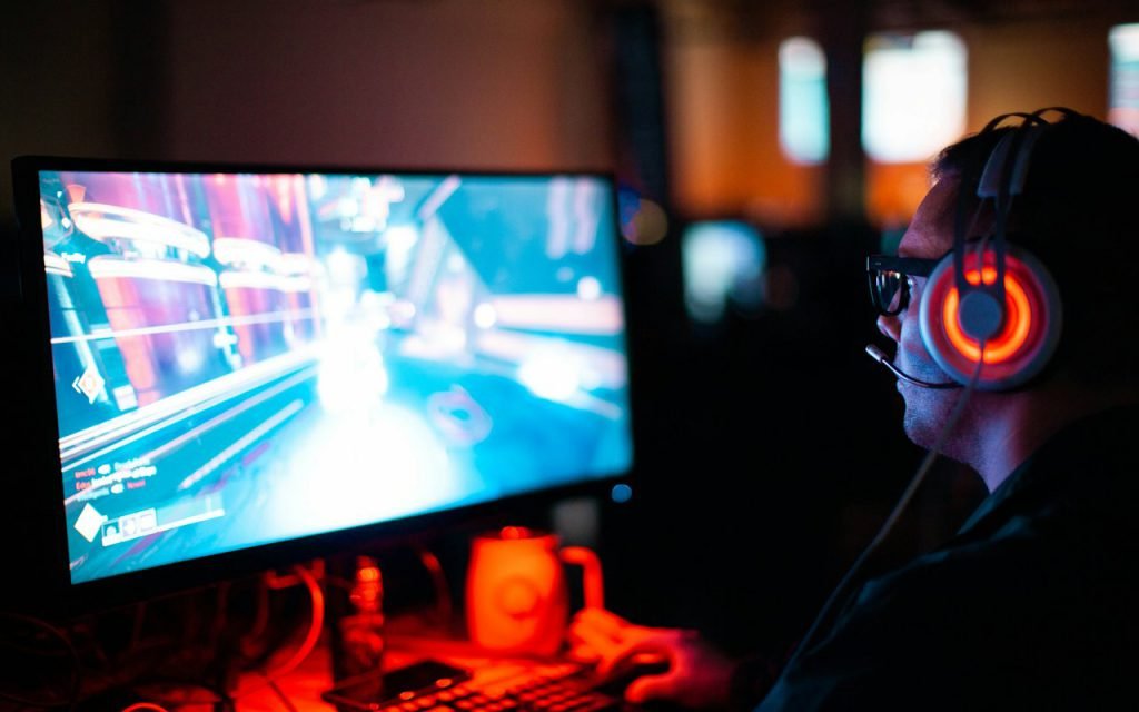 Gaming desk setup with monitor and colorful lighting