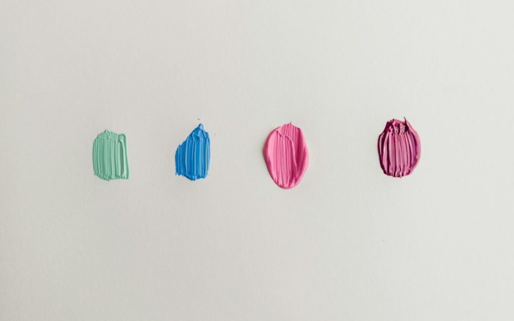 Paint color swatches fanned out on a table