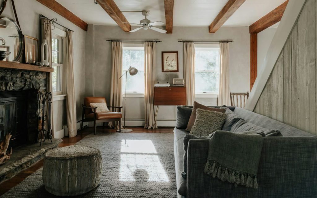 A rustic living room with wood floors and simple furniture