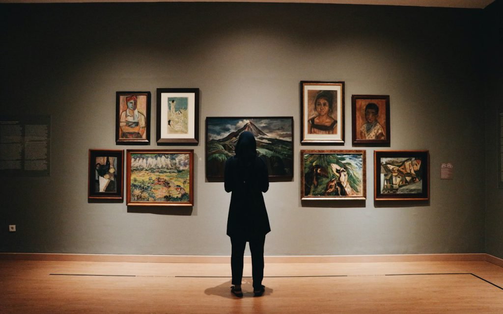 Visitors walking through a bright museum gallery