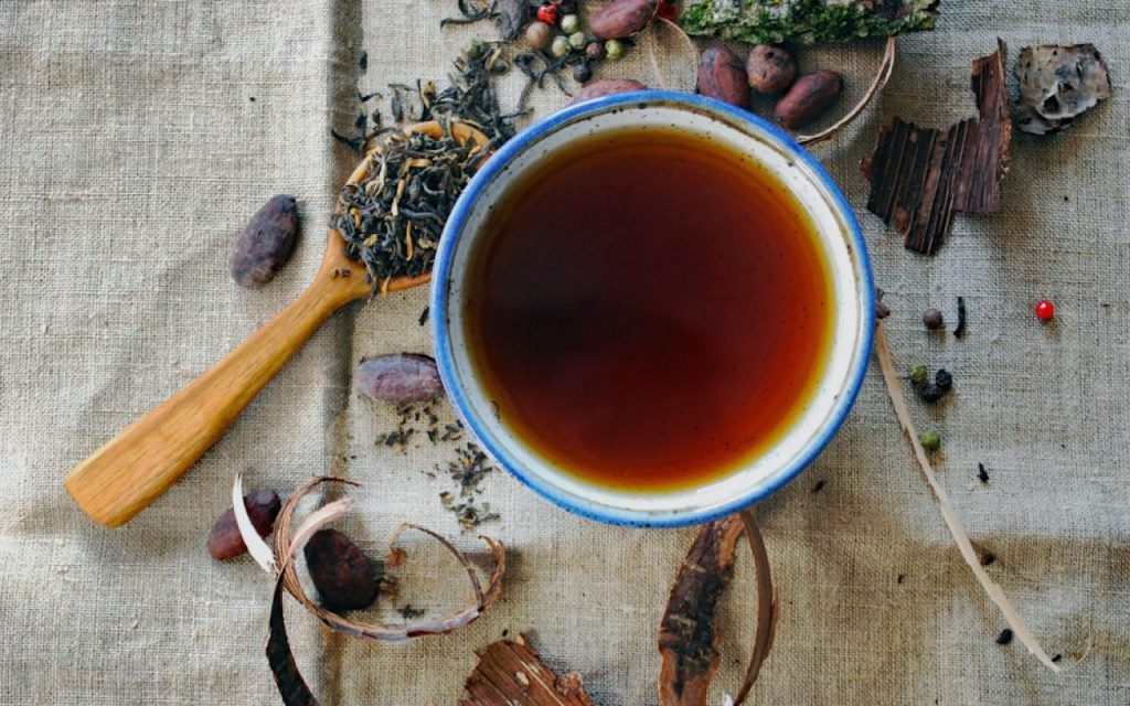 A cup of herbal tea on a table in soft evening light