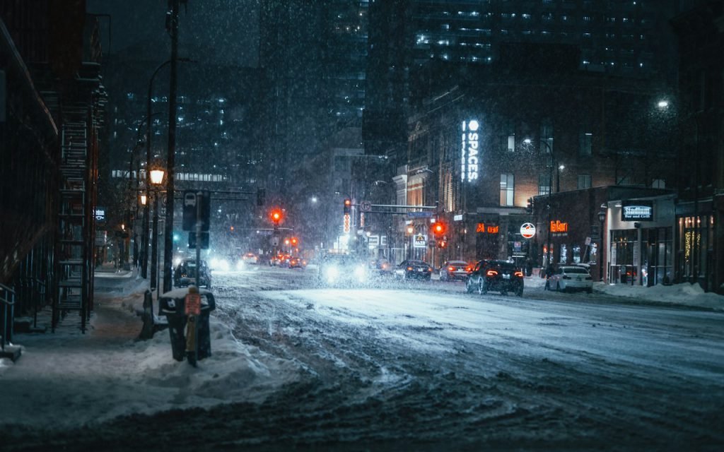 A plow clears a downtown street before dawn.