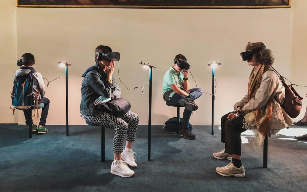 Players wearing virtual reality headsets in a dim room